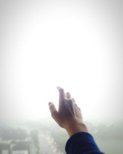 Close-up of hand against clear sky