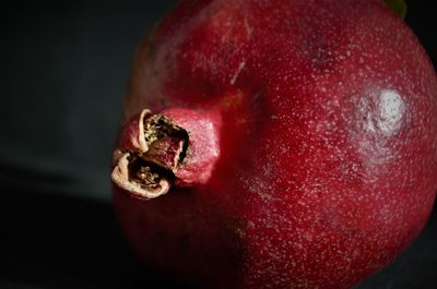 Close-up of red apple against black background