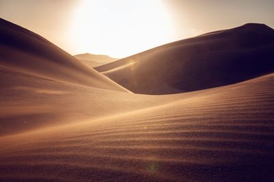 Scenic view of desert against sky during sunset