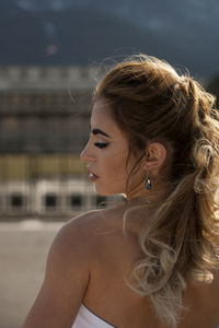 Close-up of thoughtful young bride on road