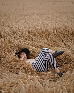 Rear view of man relaxing on field