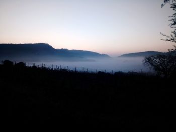 Scenic view of silhouette mountains against clear sky