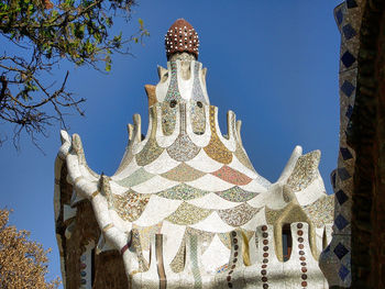 Low angle view of statue of building against blue sky