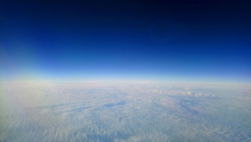 Aerial view of landscape against blue sky