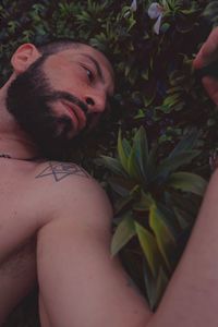 Close-up portrait of young man lying down