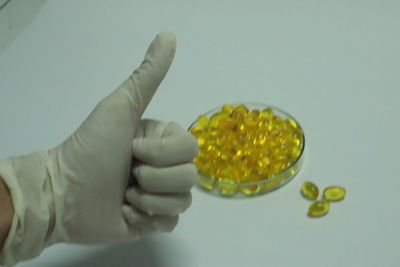 Cropped image of person holding fresh yellow over white background