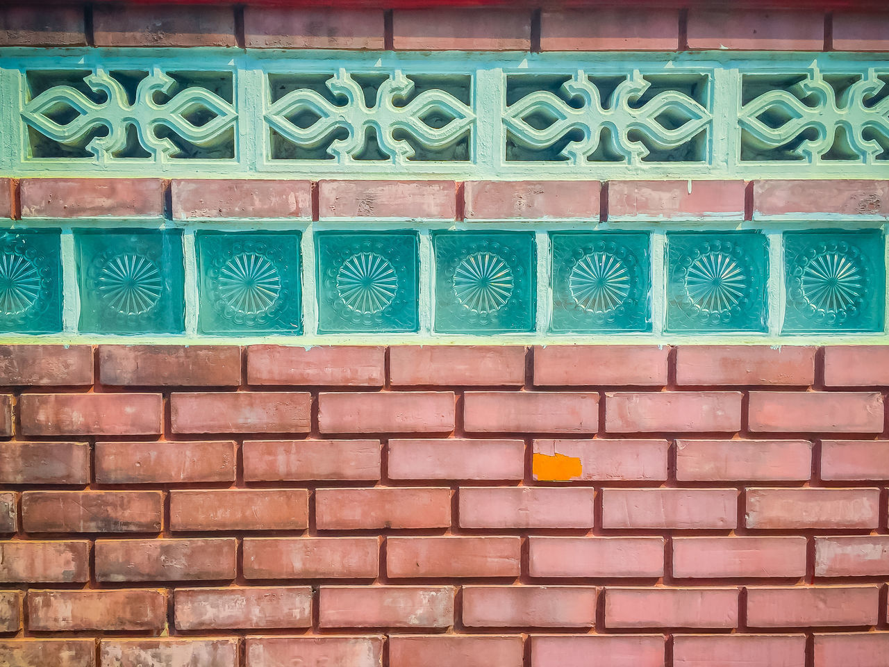 CLOSE-UP OF BRICK WALL WITH MULTI COLORED WALLS