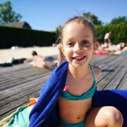 Portrait of smiling girl sitting outdoors