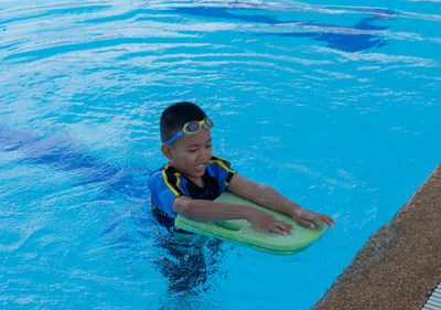 High angle view of boy swimming in pool