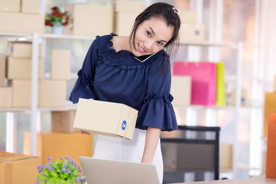 Smiling young woman standing in box