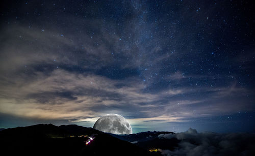 Scenic view of mountain against sky at night