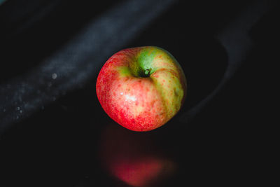High angle view of apple on table against black background