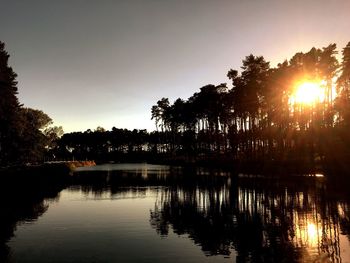 Scenic view of river at sunset