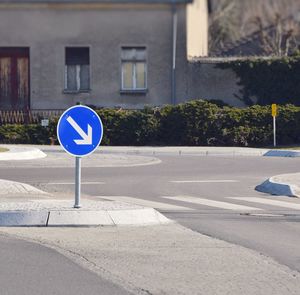 Road sign against built structure