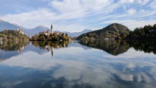 Scenic view of lake by trees against sky