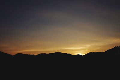 Silhouette landscape against sky during sunset