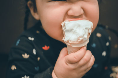 Midsection of woman eating ice cream
