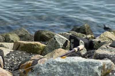 High angle view of cigarette on rocks at beach