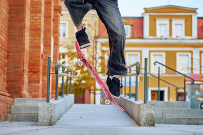 Low section of man walking on steps