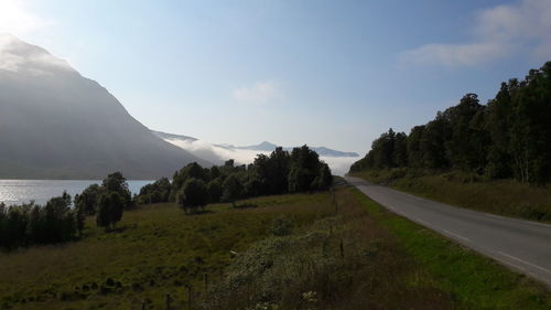 Road by landscape against sky