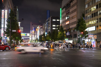 View of city street and buildings at night