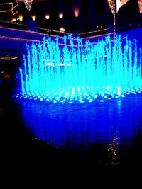 Illuminated blue water at night