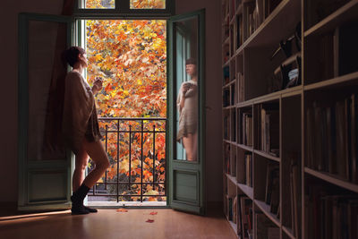 Side view of woman standing in park during autumn