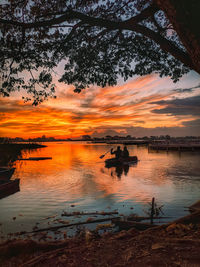 Scenic view of lake against orange sky