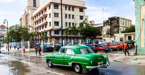 Cars on street against buildings in city