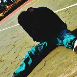 High angle view of man sleeping on footpath