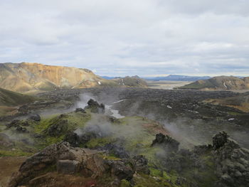 Scenic view of mountains against cloudy sky