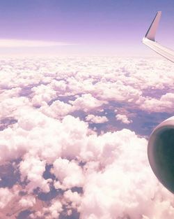 Aerial view of cloudscape over airplane wing