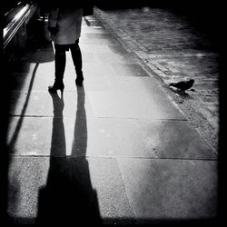 Low section of woman standing on tiled floor