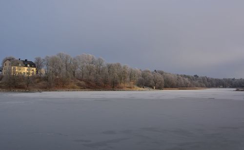 Scenic view of snow covered land against clear sky