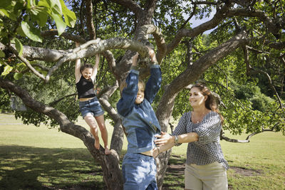 Girls climbing tree