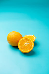 Oranges photographed on a light blue background.