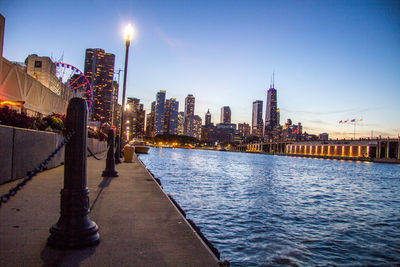 View of river with illuminated buildings in background