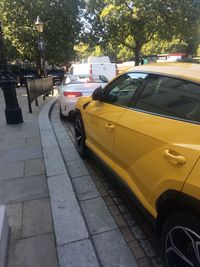 View of yellow car parked on street