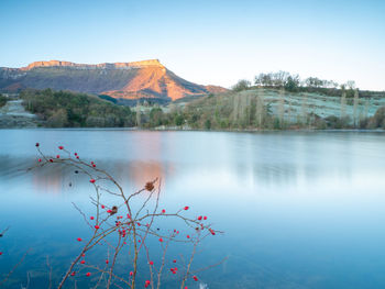 Scenic view of lake and mountains against clear sky