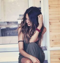 Young woman sitting on floor
