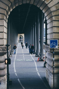 Group of people walking on road in city