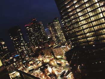 Aerial view of illuminated buildings in city at night