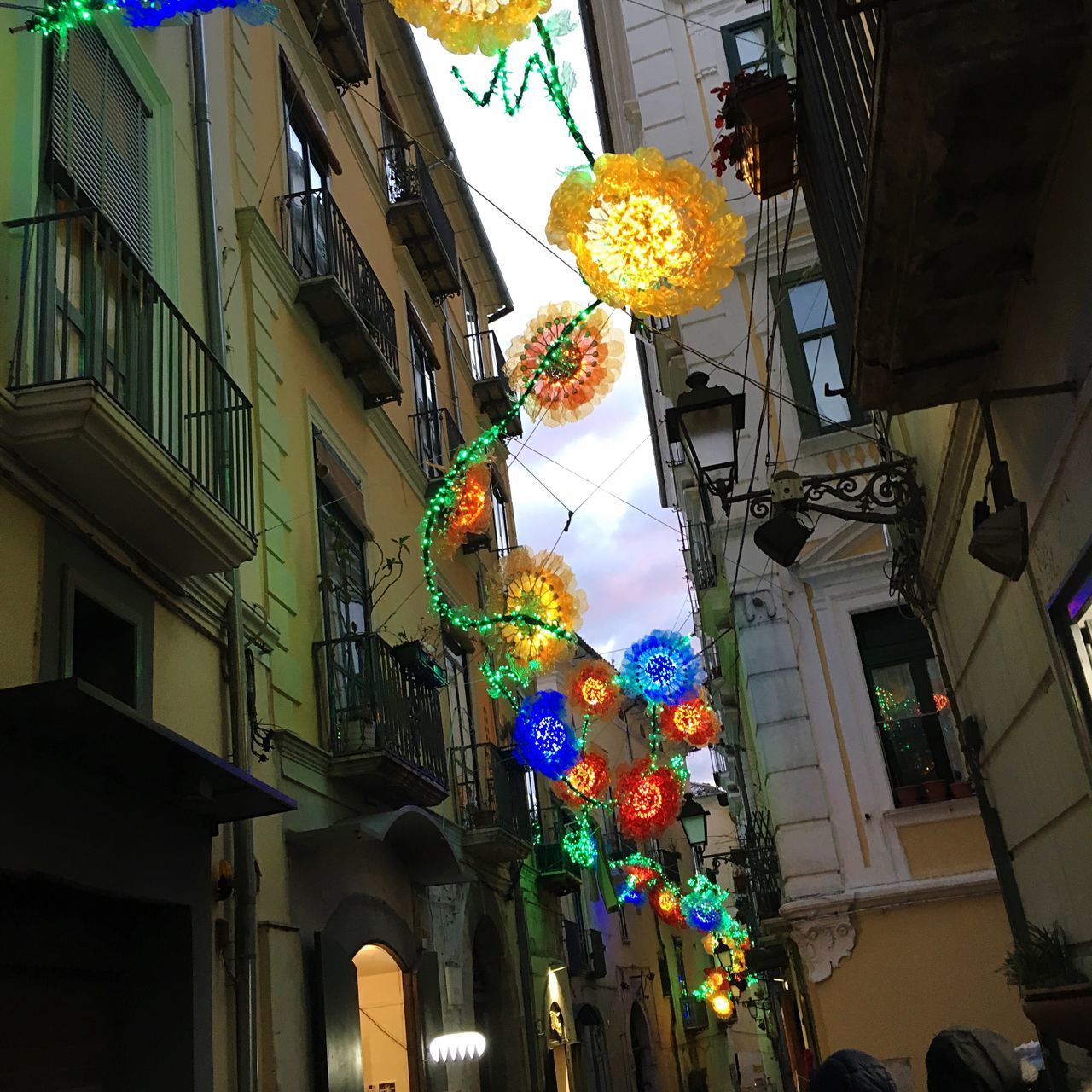 building exterior, architecture, built structure, city, street, illuminated, multi colored, lighting equipment, hanging, low angle view, outdoors, travel destinations, no people, sky, chinese lantern festival, skyscraper, day