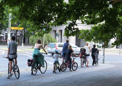 People riding bicycles on street in city