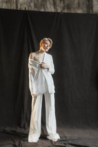 Young stylish woman businesswoman in white suit