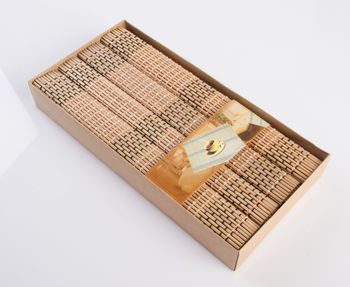 High angle view of bamboo place mats in box on gray background