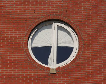 Close-up of window on red brick wall