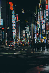 Illuminated city street and buildings at night