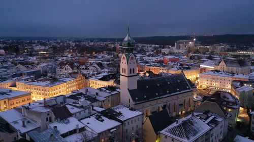 High angle view of illuminated town against sky at dusk