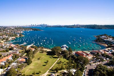 High angle view of townscape by sea against sky